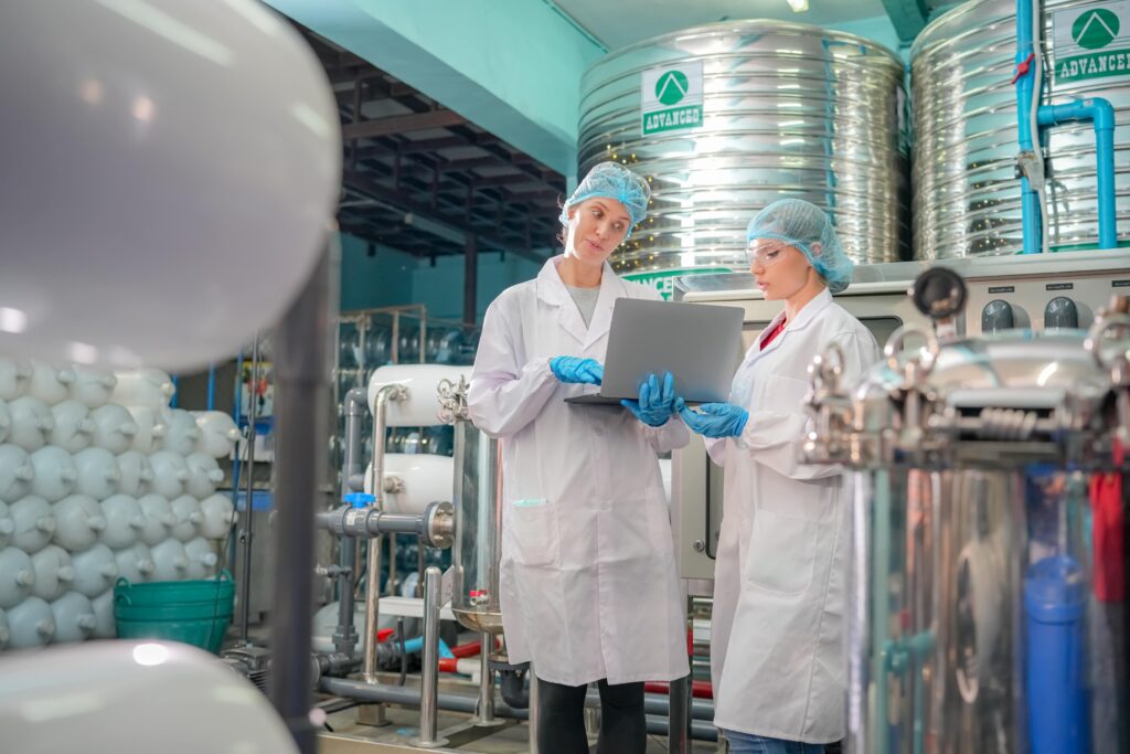 female-worker-inspecting-water-bottle-on-productio-2023-11-27-05-27-02-utc-min
